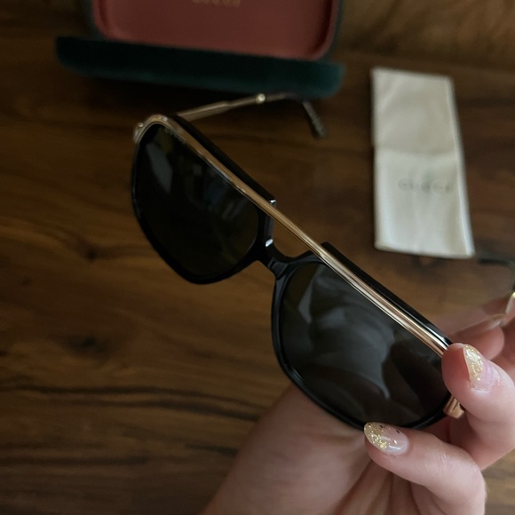 Gucci Black Frame Sunglasses with Gold Trim